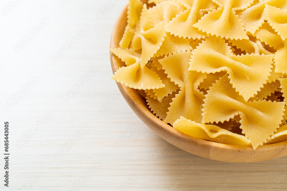 Dry uncooked farfalle pasta in bowl Dry uncooked farfalle pasta in bowl