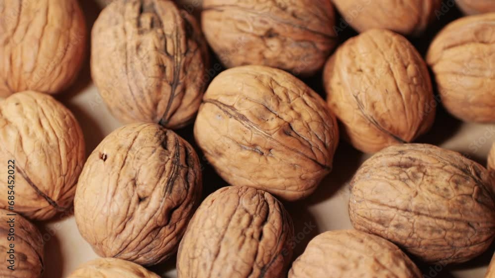 Walnuts in a shell rotating top view. Healthy snacks. Product rich in minerals and vitamins. Walnuts in a shell rotating top view. Healthy snacks. Product rich in minerals and vitamins.