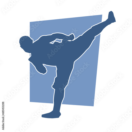 Silhouette of a male kickboxing athlete in action pose. Silhouette of a kickboxer man doing martial art pose.