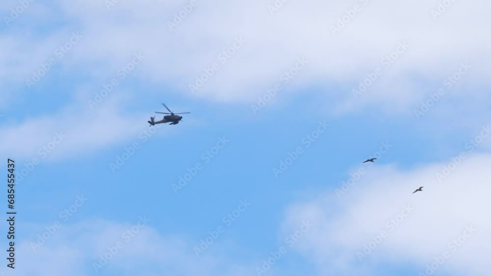 Army helicopter flying overhead carrying weapons, Gaza war footage establishing shot Army helicopter flying overhead carrying weapons, Gaza war footage establishing shot