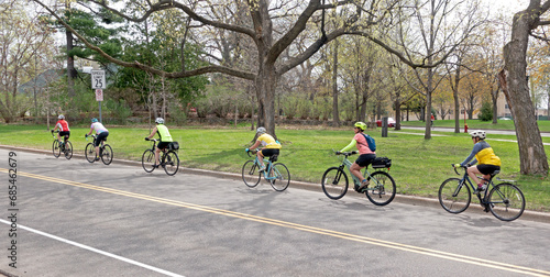 Bicycle group riding on the Mississippi River Boulevard near the monument. St Paul Minnesota MN USA