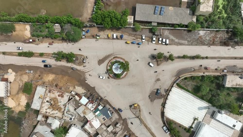 Aerial Birds Eye View Over Traffic Going Around Allaha Wala Chowk Roundabout. Pedestal Up photo