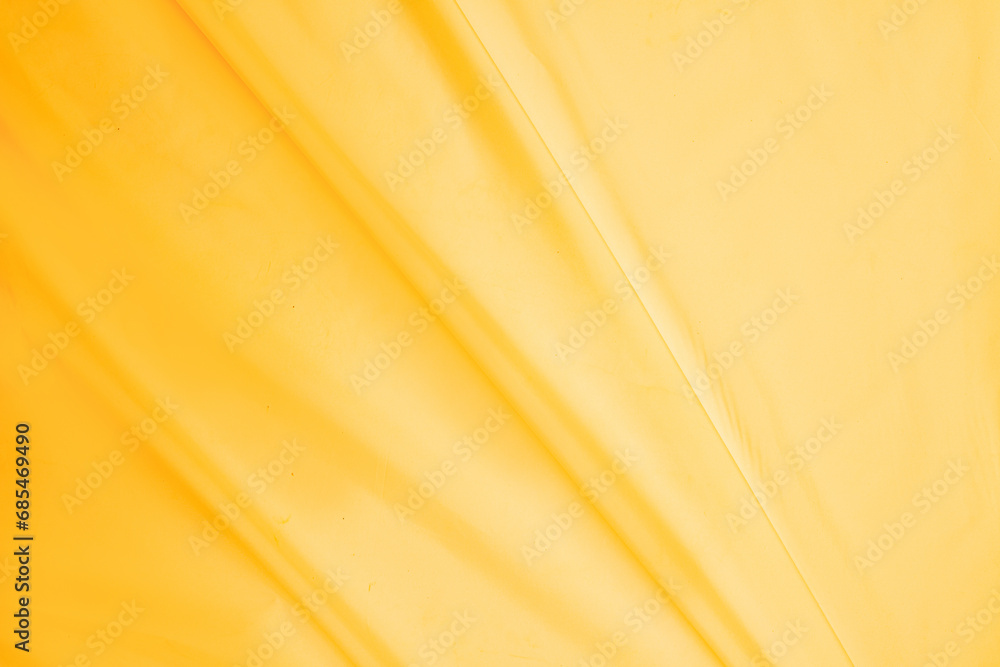 Yellow silk satin. Golden cloth. Luxurious background. Space for design templates. Flat lay, wedding, bridal, beauty, valentine, romantic