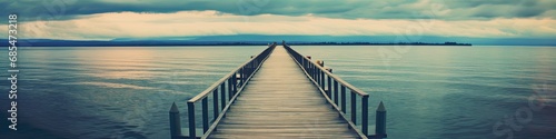 panorama of endless wooden dock over water © Ross