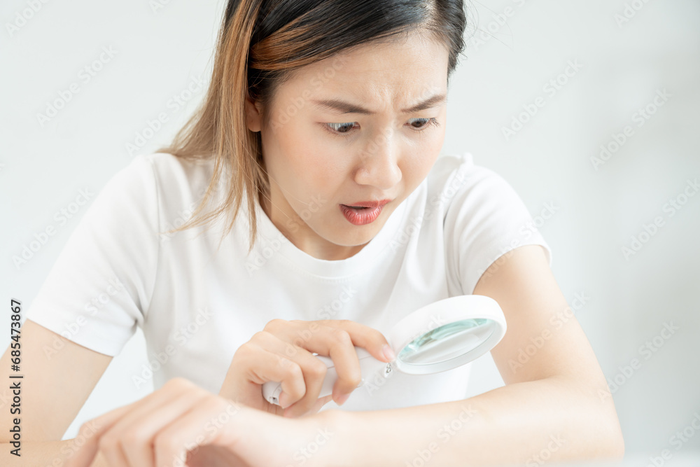 skin problem and beauty. asian woman use magnifying glass look itchy skin from skin allergic, shocked, steroid allergy, sensitive, chemical allergy, rash, insect bites, Seborrheic Dermatitis. skin problem and beauty. asian woman use magnifying glass look itchy skin from skin allergic, shocked, steroid allergy, sensitive, chemical allergy, rash, insect bites, Seborrheic Dermatitis.