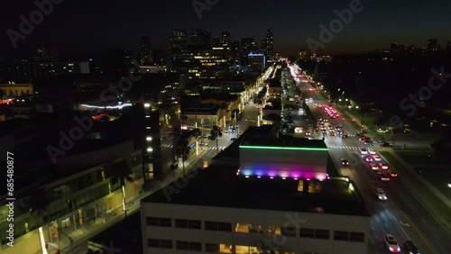 Drone shot over the colorful, night lit cityscape of Beverly Hills, Los Angeles