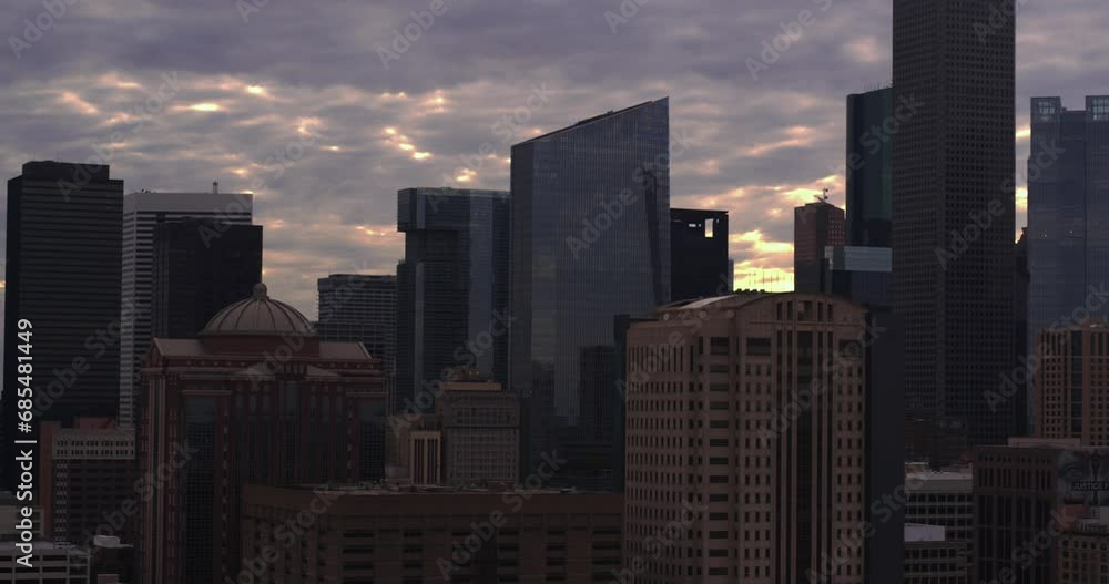 Drone dolly shot moving backwards away from downtown Houston, Texas during sunset