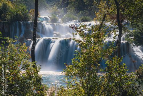 Waterfall through the trees at Krka National Park in Croatia photo