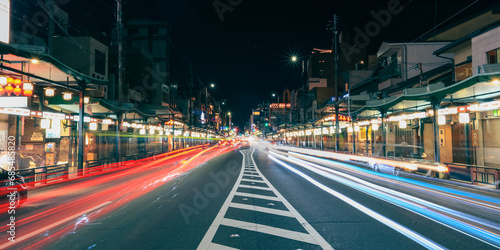 Business street with streaks of vehicle lights at world famous heritage site Gion districtin Kyota city.