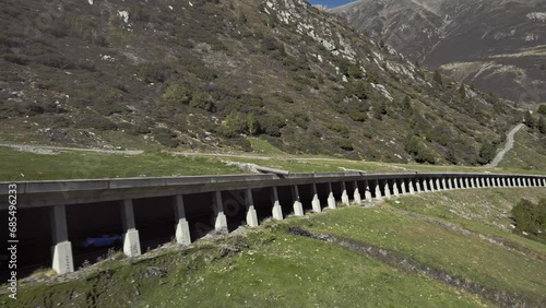 Tracking car driving in rock shed,  beautiful calming mountain alps summer sunny landscape, Kühtai, aerial photo