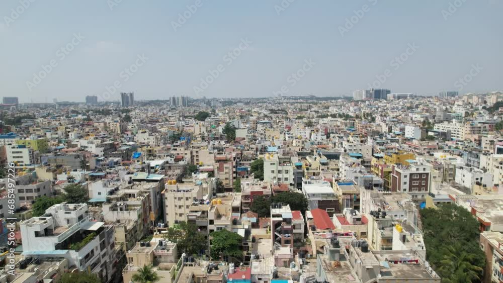 This aerial video shows Bengaluru, the capital city of Karnataka, as a bustling residential area surrounded by opulent apartment buildings. Cinematic City view Urban south india. This aerial video shows Bengaluru, the capital city of Karnataka, as a bustling residential area surrounded by opulent apartment buildings. Cinematic City view Urban south india.