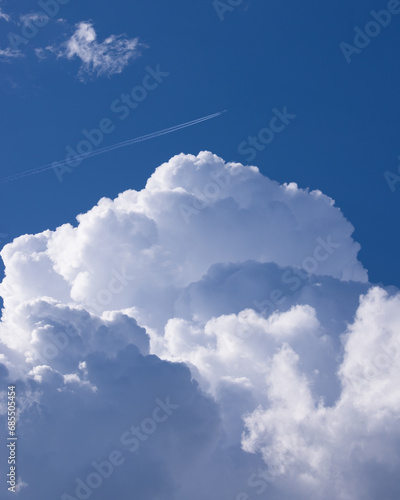 Jet plane flying blue sky with clouds photo
