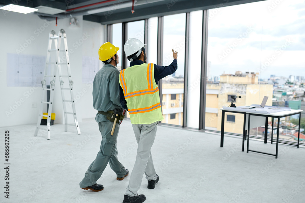 Engineer and contractor discussing how to build room divider Engineer and contractor discussing how to build room divider