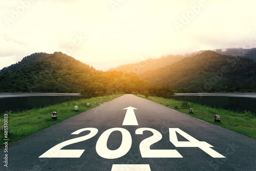 The new year 2024 or straightforward concept. Text 2024 written on the asphalt road at sunset. planning and challenge, business strategy, opportunity, hope, new life, and sustainability environment. 