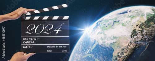 The year 2024, Hand-holding clapperboard or movie slate in video production and film industry.Storytelling of sci-fi, science and technology, global, and universe concepts. element of images furnished photo
