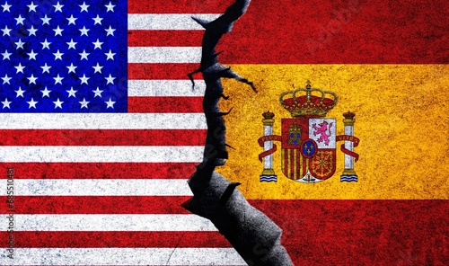 USA and Spain flags on a wall with a crack. Spain and United States of America political conflict, war crisis, economy, relationship, trade concept photo