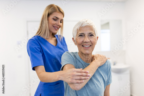 Photo of physiotherapist working with a senior female patient in her office during the day. Physiotherapist helping female patient during muscle rehabilitation physiotherapy