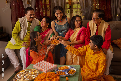 Happy Indian family celebrating Diwali together at home photo