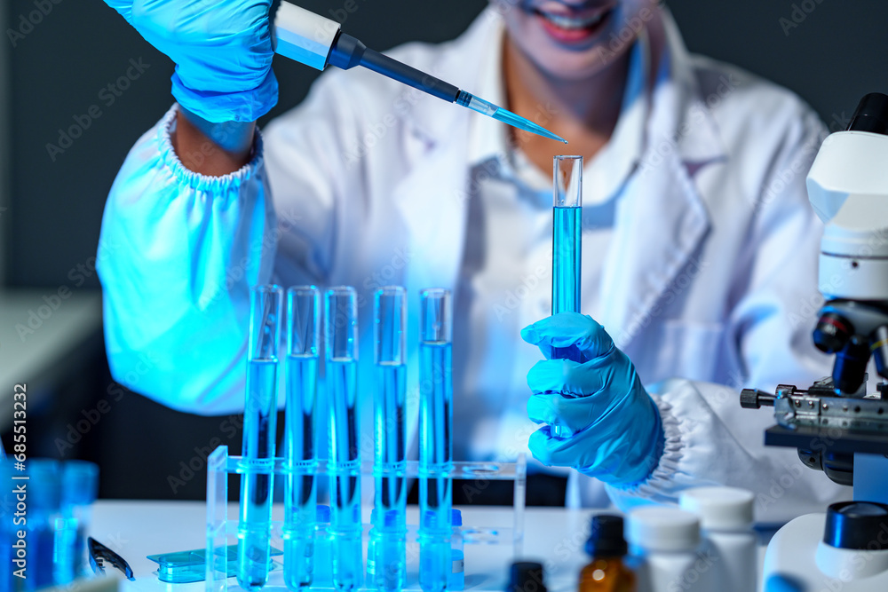 research laboratory. Female scientist uses micro pipette to release chemical liquid into test tube petri dish for test analysis for medicine. Concept of scientific research and development in biology research laboratory. Female scientist uses micro pipette to release chemical liquid into test tube petri dish for test analysis for medicine. Concept of scientific research and development in biology