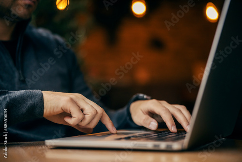 Close up of a freelancer's hands typing on a laptop.