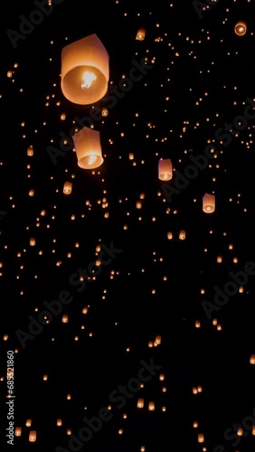 Tourist floating sky lanterns in Yi-Peng (Loy Krathong) festival , Chiang Mai ,Thailand. Vertical video.