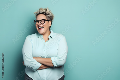 Slightly overweight businesswoman smiling confidently. Bold and vibrant clean minimalist studio portrait, copy space.