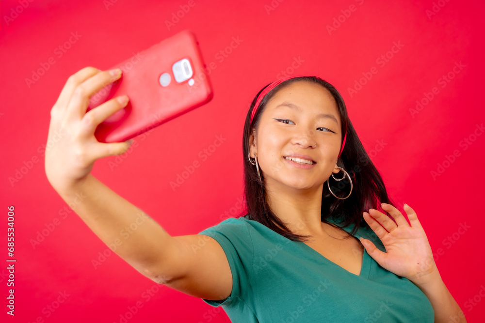 Happy chinese woman waving during a video call Happy chinese woman waving during a video call