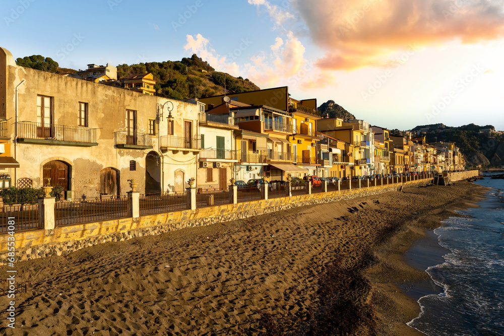 Fototapeta premium morning sunrise landscape on a city emnarkment with beach and sea coast and beautiful mediterranean street with buildings