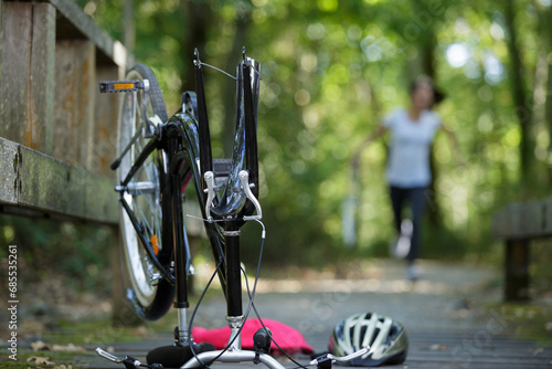 mountain biker fixing the bike chain on forest trail photo