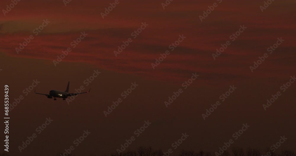 The plane is landing at sunset, pink sky, city Buenos Aires The plane is landing at sunset, pink sky, city Buenos Aires