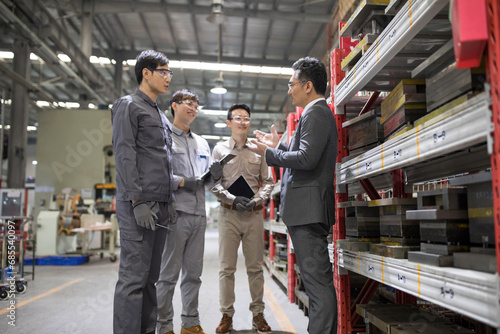 Businessman and engineers talking in the factory photo