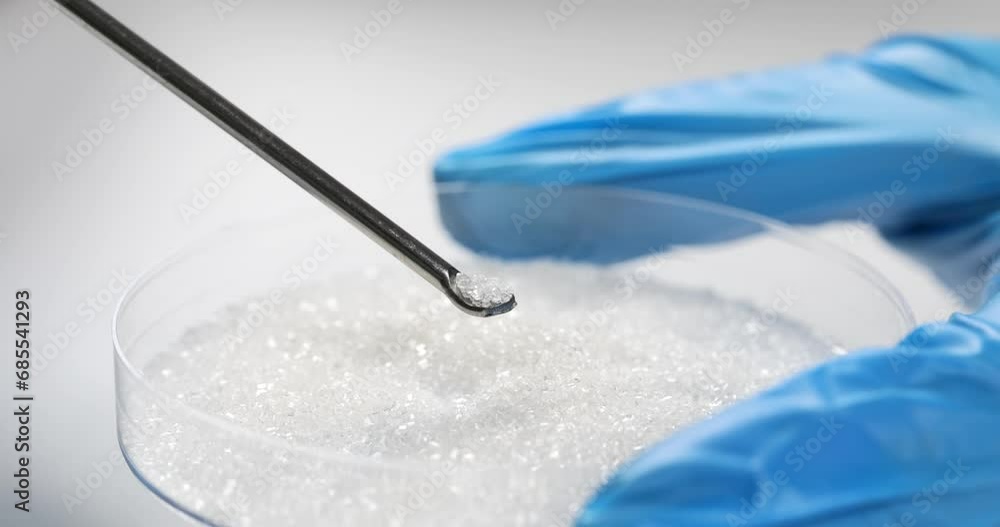 Scientist chemist taking sugar from petri dish with chemical spoon closeup 4k movie slow motion. Development of sweeteners and laboratory quality control of food products concept Scientist chemist taking sugar from petri dish with chemical spoon closeup 4k movie slow motion. Development of sweeteners and laboratory quality control of food products concept