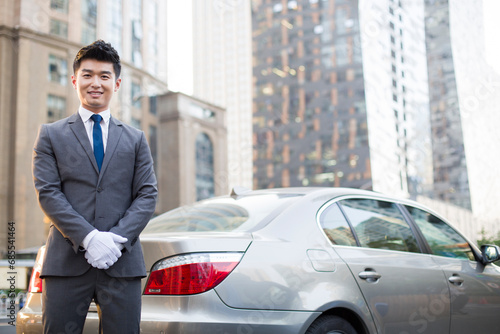 Wallpaper Mural Portrait of chauffeur standing next to the car Torontodigital.ca