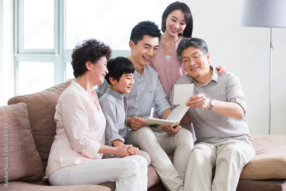Happy family looking at photo album Happy family looking at photo album