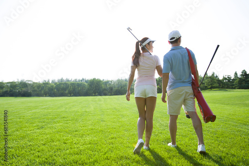 Young couple going to play golf photo