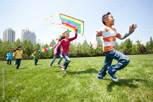 Children Playing with Kite in Field photo