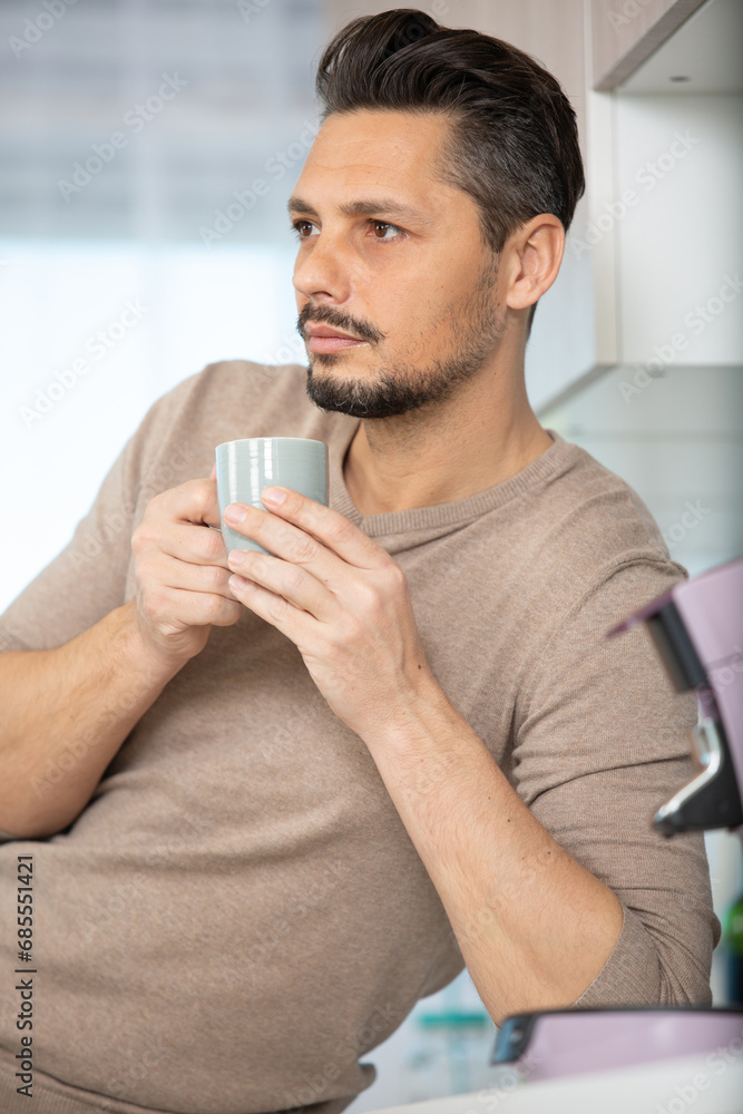 relaxed young man drink first morning coffee at home relaxed young man drink first morning coffee at home