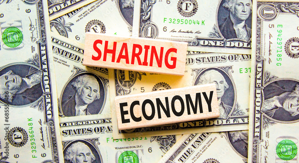 Sharing economy symbol. Concept words Sharing economy on beautiful wooden blocks. Dollar bills. Beautiful background from dollar bills. Business sharing economy concept. Copy space.