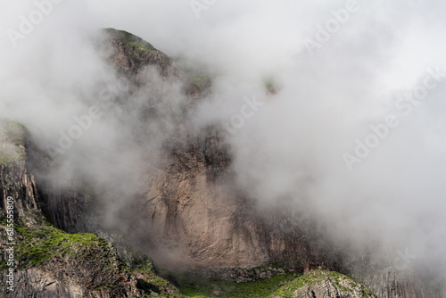 Spectacular and amazing beautiful panorama of the Andes Mountains in the Colca Canyon, Peru. White clouds, wonderful cloudscape. Cloudy cliff and rock.
