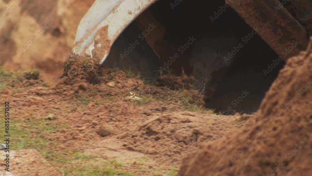 An auto excavator with a retractable and swivel bucket digs a hole to replace the pipeline. Industry An auto excavator with a retractable and swivel bucket digs a hole to replace the pipeline. Industry