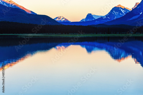 Summer evening with water reflections in a lake in the mountains
