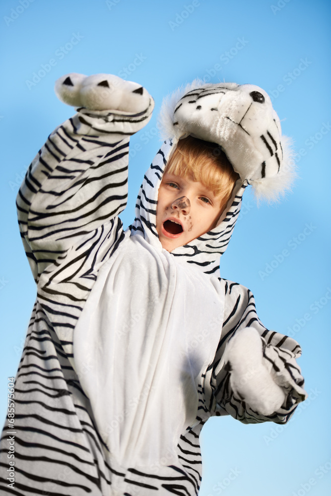 Child, tiger costume and excited for fun fashion and style on a blue studio background. Cheerful, little boy and animal clothing while playing during halloween tradition and dressing while adorable Child, tiger costume and excited for fun fashion and style on a blue studio background. Cheerful, little boy and animal clothing while playing during halloween tradition and dressing while adorable
