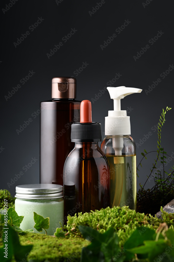 Group of skin care products with moss and leaves Group of skin care products with moss and leaves