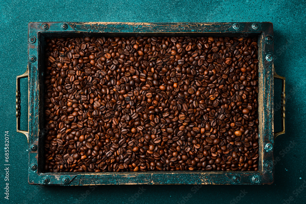 A box of Arabica or Robusta coffee beans. Coffee background. Free space for text. Top view. A box of Arabica or Robusta coffee beans. Coffee background. Free space for text. Top view.