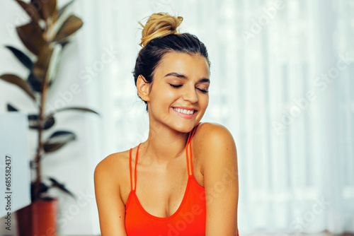 Close up portrait of fit woman smiling with eyes closed wearing red tank top Free Download Close up portrait of fit woman smiling with eyes closed wearing red tank top - GFXLoad