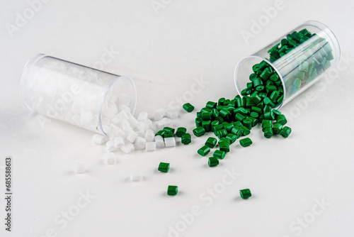 white and green plastic dye in granules in test tubes isolated on a white background photo