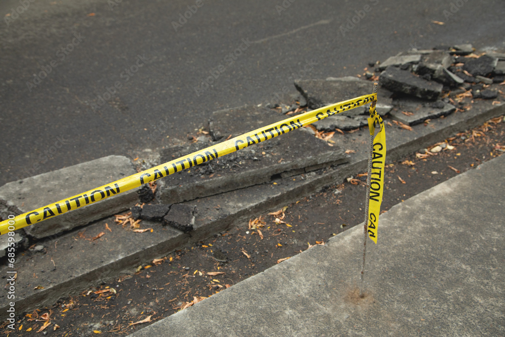 Yellow caution tape on road. Construction work Yellow caution tape on road. Construction work