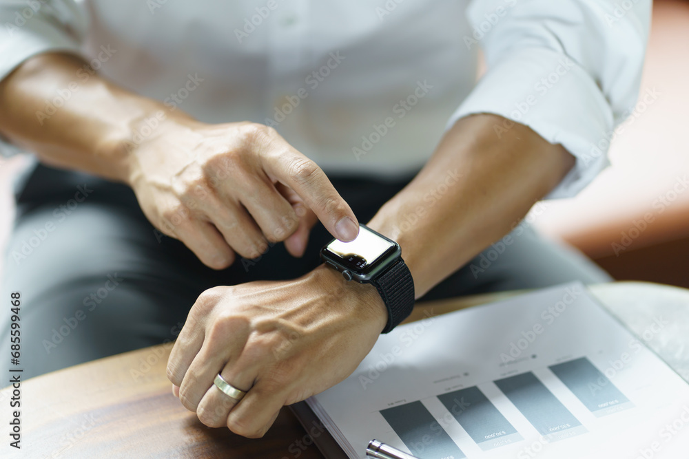 Business man Looking at smart watch In Office online connect Gadget technology Business man Looking at smart watch In Office online connect Gadget technology