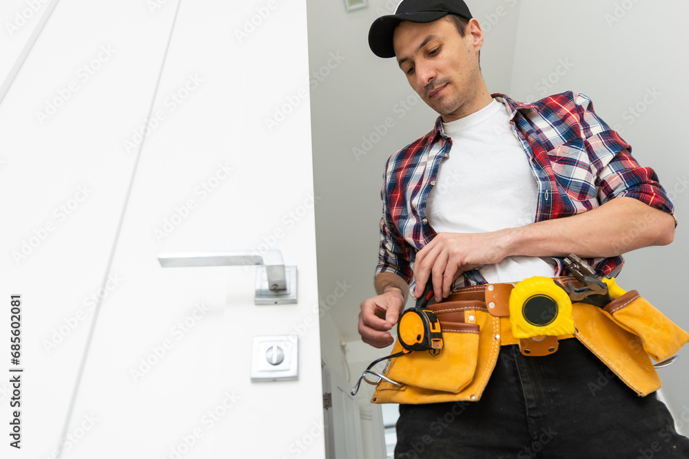Man installing door architrave repair Man installing door architrave repair