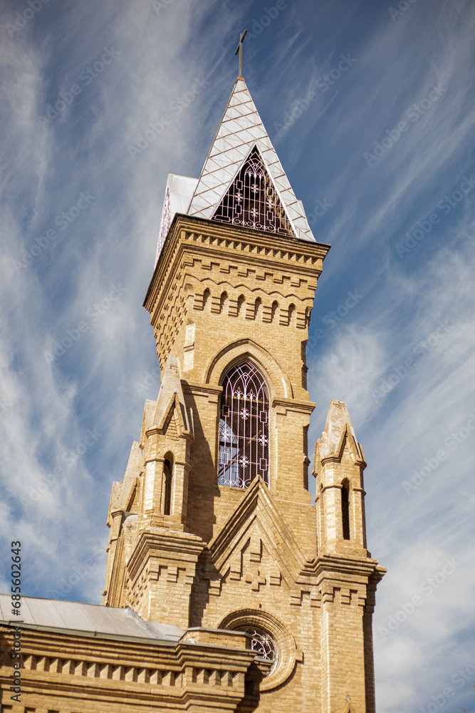 isolated Central Catholic Church with a blue sky with white clouds